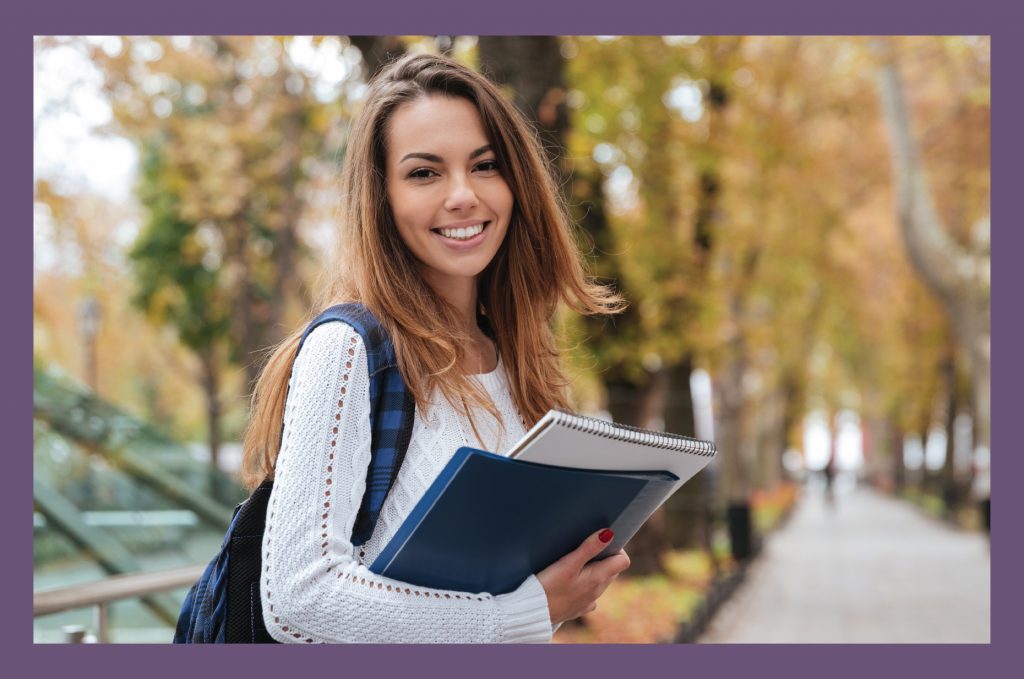 Girl holding books in fall 03